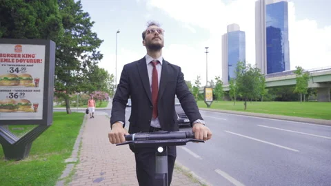 Low Angle View Of Young Man Riding Electric Scooter In The City. Stock Footage 212730126