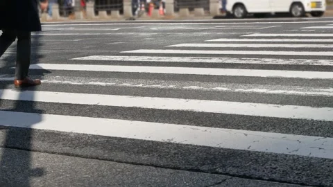 Low angle view to the at zebra crossing area at intersection while people p.. 動画素材 259605246
