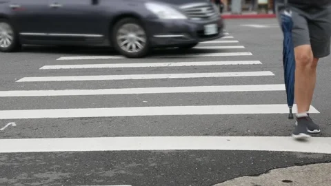 Low angle view to the at zebra crossing area at intersection while people p.. Stock Footage 309627069