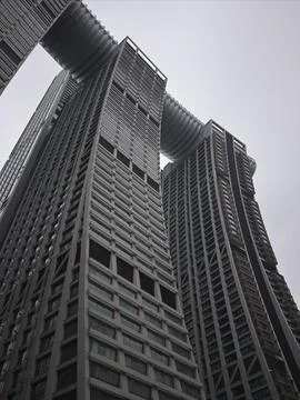 Low-angle views of curving twin towers and stacked highrise facades, China Stock Photos