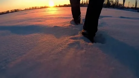 Low Angle Walking in Deep Snow at Winter Sunset Close Up Stock Footage 329616004