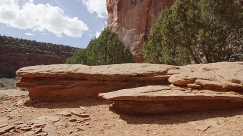 Low angle walking past large dry sheets of rock with pieces sheared off 스톡 동영상 248577738