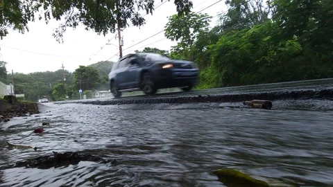 Low Angle of Water Canal on Rainy Day Road Stock Footage 221334701
