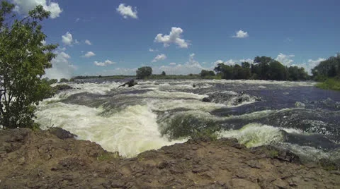 Low angle of water rushing along Zambezi River Stock Footage 22871420