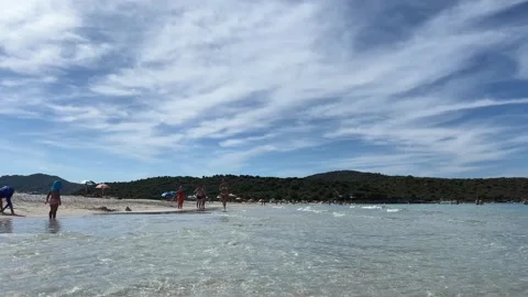 Low-angle water surface view of people bathing on white sand of lotu beach Stock Footage 280691303