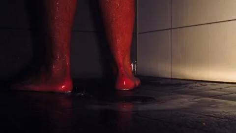 Low angle: Wet feet and hairy legs as soapy water drains from shower Stock Footage 219949947