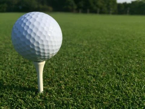 Low angle white golf ball sitting onto of tee Stock Photos