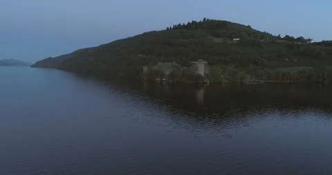 Low angle wide aerial passing the Urquhart Castle ruins looking out over Loch Vídeos de archivo 112002160