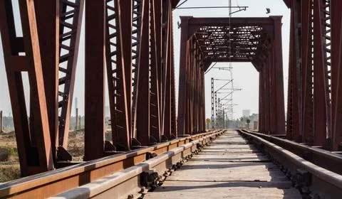 Low angle wide shot of an empty rail line with Bridge pillars around. Stock Photos