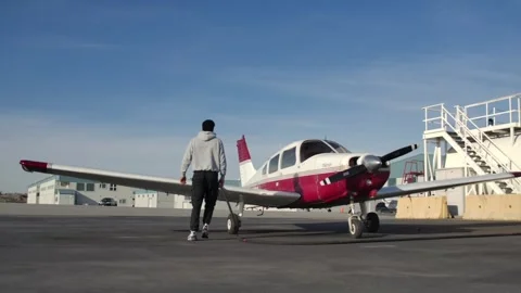 Low Angle Wide Shot of a Pilot Fueling a Piper Warrior Plane SLOMO Stock Footage 267704080