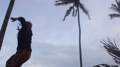 Low angle of woman dancing on beach during twilight Stock Footage 72794580