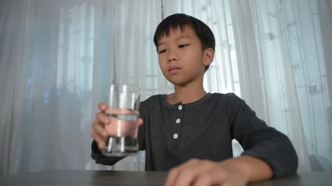 Low angle young boy drink water Stock Footage 113535812