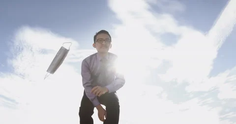 Low Angle of Young Malay Man in Office Wear Throwing Face Mask Away Then Smiles Stock Footage 135098470