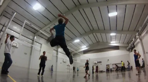 Low Angle of Young Volleyball Player Jumping and Spiking the Volleyball Stock Footage 33604694
