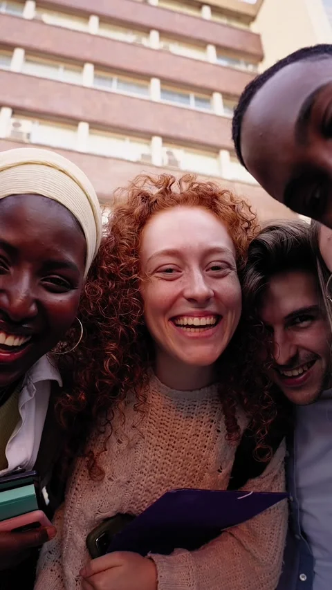 Low angle zoom. Group multiracial and diverse young students laughing looking at Stock Footage 316966693