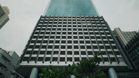 Low-Angle Zoom-In View of Modern Glass Skyscraper Stock Footage 309932831