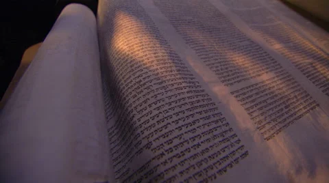 Low angled close-up of opened Torah scroll, left to right fly-over of page Stock Footage