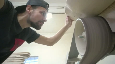 Low angled look at man grinding wheel well Stock Footage 58301589