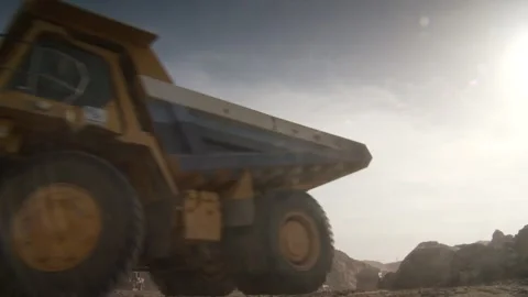 A low angled mid shot of a construction vehicle moving Stock Footage 312400427