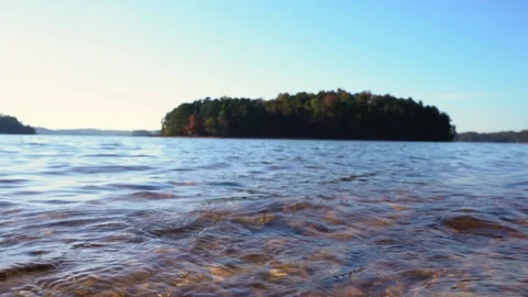 A low angled shallow depth of field view of lake water. Stock Footage 119334660