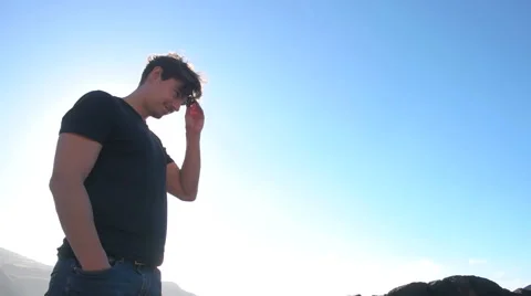 Low angled shot of man putting on sunglasses Stock Footage 59337384