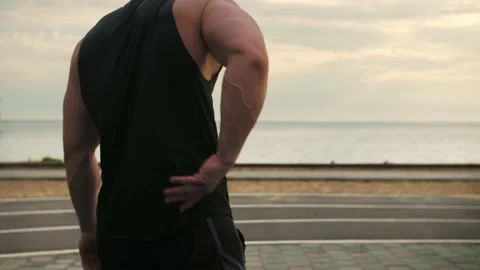 Low back pain in an athlete. Training in the street.Slow Motion Stock Footage 200118762