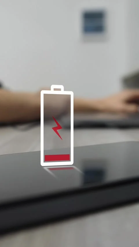 Low battery notification appears on mobile smartphone in office, man working Stock Footage 324791402