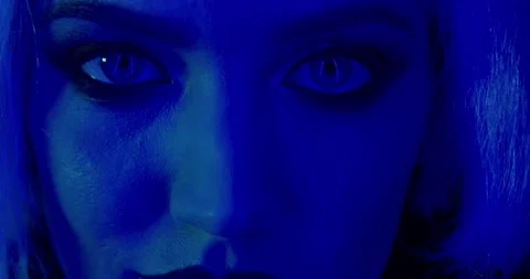 Low blue light, young beautiful woman with blue eyes, close up, 4k Stock Footage 132780693