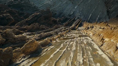 Low camera moves backs down rock slippery formations Stock Footage 112294991