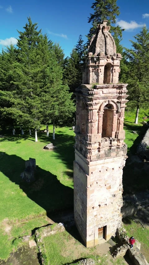 Low close orbit around a weathered stone ruin tower Stock Footage 346015794