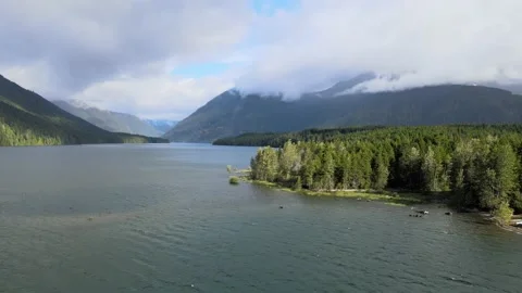 Low cloud rainforest, mountain, hills, dark blue water, green valley Stock Footage 155725530