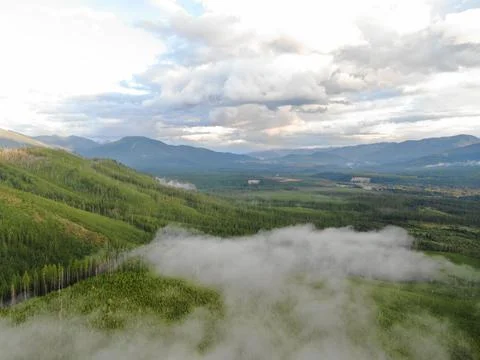 Low clouds above forest landscape and river in Montana Stock Photos