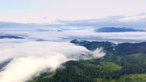 Low clouds and mist over mountain valley in Norway at sunrise Video stock 319739264