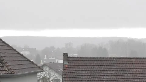 Low clouds and rain above the village and hills 스톡 동영상 331786401