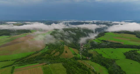 Low clouds covering part of the landscape. Heavy clouds, green vegetation. Mist Video stock 253493697