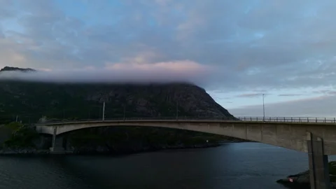 Low Clouds Draping Mountain Above Concrete Bridge in Lofoten Norway at Dusk Stock Footage 340009222