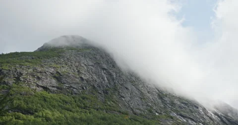 Low Clouds Draping Rocky Peak, Trollstigen, Norway Stock Footage 323677986