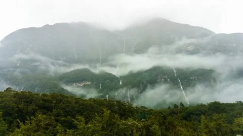 Low Clouds Drifiting Over Forrested Mountain Video stock 50100876