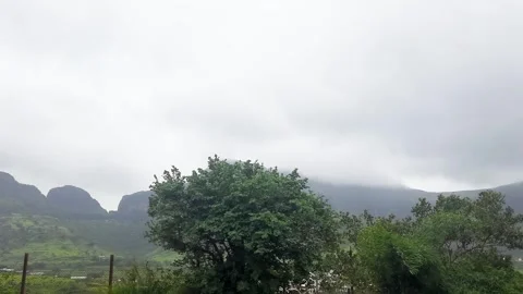 Low Clouds Drifting Over Green Mountain Range Under Dramatic Sky Vídeo Stock 342584216