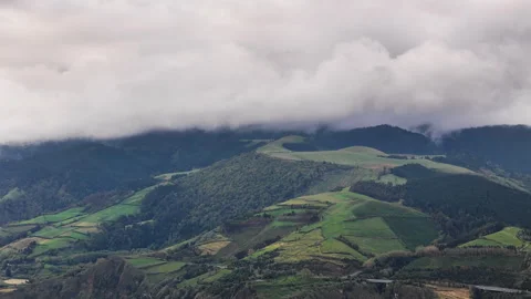 Low clouds drifting over rolling green hills on Sao Miguel Island Stock Footage 335986990