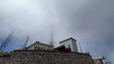 Low Clouds Engulfing Mountain Communication Tower Stock Footage 341818104