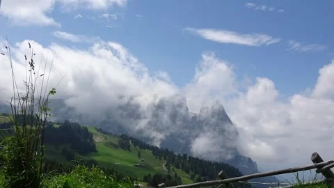 Low clouds enveloping the mountains. Alpe di Siusi or Seiser Alm, Dolomites.. Stock Footage 247317391