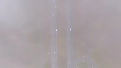 Low clouds flow over car traffic in road Video stock 106084611