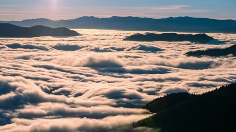 Low clouds flow like a river in alpine mountains nature landscape Time lapse Stock Footage 144550718