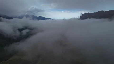 Low clouds in the mountains. Aerial view of low fog in mountainous area Stock Footage 241071827