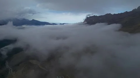 Low clouds in the mountains. Aerial view of low fog in mountainous area Stock Footage 241072804