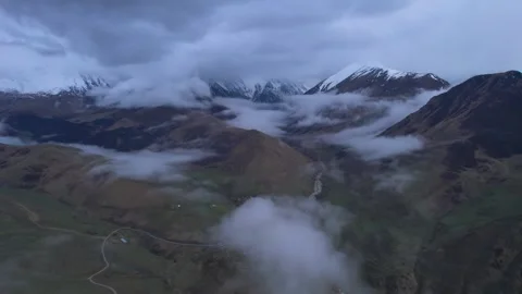 Low clouds in the mountains. Aerial view of low fog in mountainous area Stock Footage 241073211