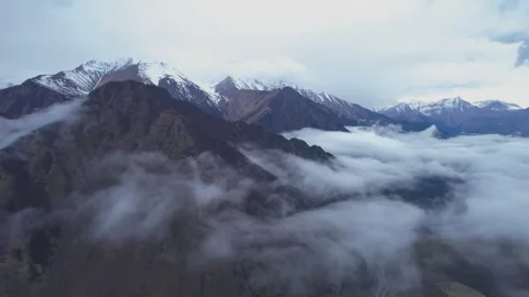 Low clouds in the mountains. Aerial view of low fog in mountainous area Stock Footage 241073235