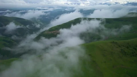 Low clouds in the mountains. Aerial view of low fog in mountainous area Stock Footage 241185266