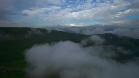 Low clouds in the mountains. Aerial view of low fog in mountainous area Stock Footage 241185373